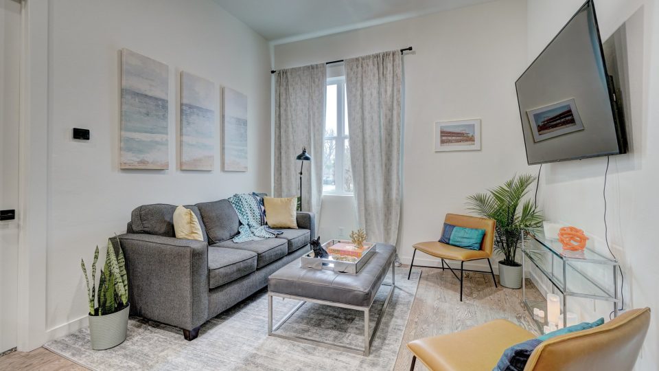 a living room with a couch, coffee table, and television at The  Campbell