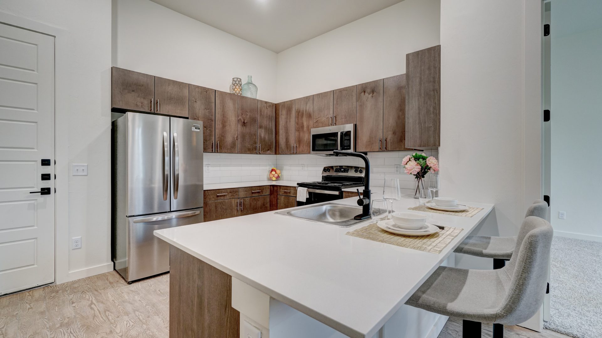 a kitchen with stainless steel appliances and white cabinets at The  Campbell