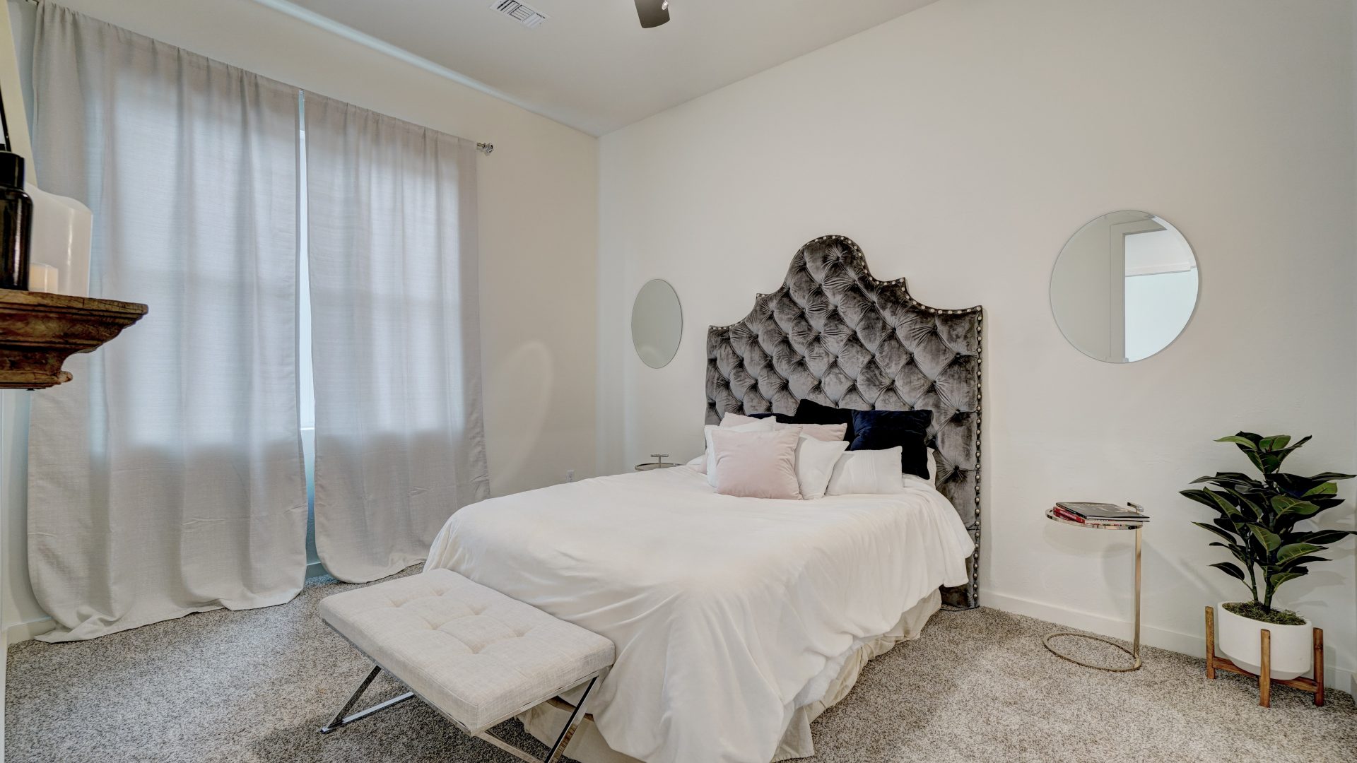 a bedroom with a white bed and a ceiling fan at The  Campbell