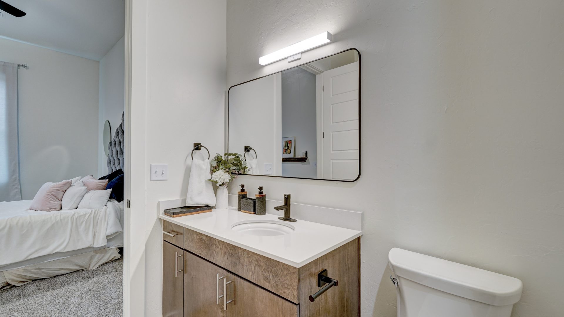 a bathroom with a sink, toilet and mirror at The  Campbell